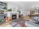 Bright living room features a stone fireplace, built-in shelving, and seamless flow into the dining area at 5211 Routt Ct, Arvada, CO 80002
