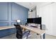 Modern home office with sleek desk, comfortable chair, and stylish wall paneling for a professional workspace at 5211 Routt Ct, Arvada, CO 80002