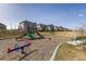 Community playground with swings, slides and nearby seating at 5211 Routt Ct, Arvada, CO 80002