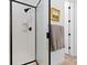 Modern shower with black trim and subway tile, creating a sleek look at 5211 Routt Ct, Arvada, CO 80002
