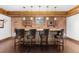 Basement bar with brick walls, custom cabinetry, and bar stools at 930 E 7Th Ave, Denver, CO 80218