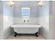 Bathroom with clawfoot tub and subway tile at 930 E 7Th Ave, Denver, CO 80218