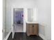 Modern bathroom with subway tile, glass shower, and wood vanity at 930 E 7Th Ave, Denver, CO 80218