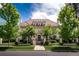 Stately home featuring manicured lawn, mature trees, a gated entrance and a red tile roof at 930 E 7Th Ave, Denver, CO 80218
