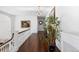 Elegant hallway with hardwood floors, chandelier, and white railings at 930 E 7Th Ave, Denver, CO 80218