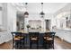 Elegant kitchen with a large center island, custom cabinetry, and hardwood floors at 930 E 7Th Ave, Denver, CO 80218
