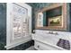 Stylish powder room features decorative wallpaper, a marble vanity top, and elegant fixtures at 930 E 7Th Ave, Denver, CO 80218