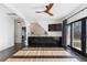 Modern wet bar with dark cabinetry and a large TV at 930 E 7Th Ave, Denver, CO 80218