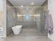 Sleek bathroom featuring a modern soaking tub and glass enclosed shower at 1587 Arrowpoint Ct, Franktown, CO 80116