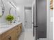 Modern bathroom with double vanity, wood cabinets, black fixtures, and an open shower at 1587 Arrowpoint Ct, Franktown, CO 80116