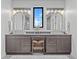 Modern bathroom with double sinks, antler mirror accents and vanity area at 1587 Arrowpoint Ct, Franktown, CO 80116