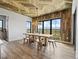 A bright dining room features wood floors, a wood plank ceiling, and gorgeous views at 1587 Arrowpoint Ct, Franktown, CO 80116