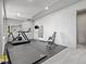 Home gym featuring modern exercise equipment, rubber flooring, and a large mirror for an effective workout space at 1587 Arrowpoint Ct, Franktown, CO 80116