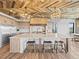 An open kitchen with a large island, wooden ceiling, and high-end appliances at 1587 Arrowpoint Ct, Franktown, CO 80116