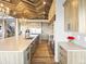 Kitchen boasting a central island, modern appliances, and herringbone-patterned wooden ceiling at 1587 Arrowpoint Ct, Franktown, CO 80116