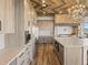 Gourmet kitchen featuring stainless steel appliances, wooden cabinets, and unique wooden ceiling at 1587 Arrowpoint Ct, Franktown, CO 80116