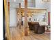 Open-concept living room boasts wood beams, hardwood floors, and seamless transition to an adjacent chef's kitchen at 1587 Arrowpoint Ct, Franktown, CO 80116
