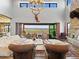 The living room boasts soaring ceilings, a stone fireplace, and expansive outdoor views at 1587 Arrowpoint Ct, Franktown, CO 80116