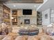 Inviting living room with stone fireplace, wood paneling, and rustic decor for a cozy, natural ambiance at 1587 Arrowpoint Ct, Franktown, CO 80116