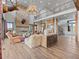 A spacious living room featuring a stone fireplace, antler chandelier, and an open-concept layout at 1587 Arrowpoint Ct, Franktown, CO 80116