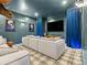 Home theater room with large screen, modern sofa, and blue accent lighting for immersive entertainment at 1587 Arrowpoint Ct, Franktown, CO 80116