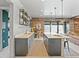 Modern wet bar in recreation room features sleek countertops and wine storage with backyard access at 1587 Arrowpoint Ct, Franktown, CO 80116