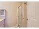 Bright bathroom with a shower featuring glass doors at 2223 S Buckley Rd # 102, Aurora, CO 80013