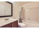 Bathroom features a tub, shower, white tile, and a wood vanity at 2223 S Buckley Rd # 102, Aurora, CO 80013