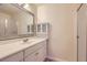 Bright bathroom with a large vanity, framed mirror, and a shower with glass door at 2223 S Buckley Rd # 102, Aurora, CO 80013