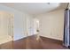 Spacious bedroom boasts dark hardwood floors, neutral paint, and multiple doors and closet access at 2223 S Buckley Rd # 102, Aurora, CO 80013
