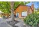Attractive home exterior with a well-maintained lawn, mature trees, and a charming brick chimney at 2223 S Buckley Rd # 102, Aurora, CO 80013