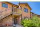 Charming exterior showcasing brick facade, private balcony, and lush landscaping at 2223 S Buckley Rd # 102, Aurora, CO 80013