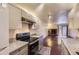 Modern kitchen featuring modern appliances, countertops, ample cabinetry, and open living area at 2223 S Buckley Rd # 102, Aurora, CO 80013