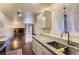 Bright kitchen featuring modern countertops and cabinetry adjacent to living room with fireplace at 2223 S Buckley Rd # 102, Aurora, CO 80013