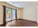 A well lit empty living room with hardwood floors and sliding glass doors at 2223 S Buckley Rd # 102, Aurora, CO 80013