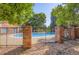 Beautiful community pool with a pristine blue swimming area surrounded by a decorative wrought iron fence at 2223 S Buckley Rd # 102, Aurora, CO 80013