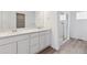 Well-lit bathroom featuring double sinks, a large vanity, and a glass shower at 9683 Ceylon St, Commerce City, CO 80022