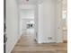 Bright foyer featuring wood-look flooring, leading to an open-concept living space at 9683 Ceylon St, Commerce City, CO 80022