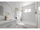 Updated bathroom with marble tile, bathtub, and modern vanity at 5329 Flower Cir, Arvada, CO 80002