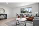 Living room featuring a leather sofa, coffee table, and geometric rug at 5329 Flower Cir, Arvada, CO 80002