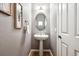 Stylish powder room with pedestal sink, decorative mirror, and wood look flooring at 3030 Wyandot St # 4, Denver, CO 80211