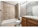 Cozy bathroom featuring a tub with tiled surround and a wooden vanity at 3030 Wyandot St # 4, Denver, CO 80211