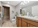 Well-lit bathroom featuring tiled floors, a glass enclosed shower, and a wooden vanity at 3030 Wyandot St # 4, Denver, CO 80211