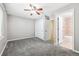 Spacious bedroom featuring a ceiling fan, large closet doors, and carpeted flooring at 3030 Wyandot St # 4, Denver, CO 80211