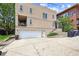 Multi-level home exterior with a garage, balcony, and landscaping at 3030 Wyandot St # 4, Denver, CO 80211