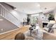 Open-concept living room, dining area, and staircase with plenty of light at 3030 Wyandot St # 4, Denver, CO 80211