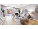 Bright living room featuring a fireplace, light walls, stylish decor, and sliding glass doors to a balcony at 3030 Wyandot St # 4, Denver, CO 80211