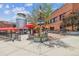 Outdoor seating area with umbrella shaded tables near Little Personal Ice Cream shop at 3030 Wyandot St # 4, Denver, CO 80211