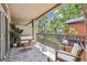 Private covered patio with stylish outdoor furniture and views of mature trees and sky at 3030 Wyandot St # 4, Denver, CO 80211