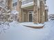 Back porch with a sliding door to the condo unit offers a cozy outdoor retreat covered in fresh snow at 7440 S Blackhawk St # 9-108, Englewood, CO 80112